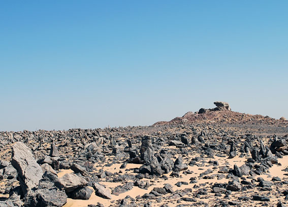 Field of upright stones with the sanctuary at Gebel Tingar in the background