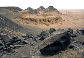 Half-finished statue at the Old Kingdom basalt quarries with the Widan el-Faras peaks in the background