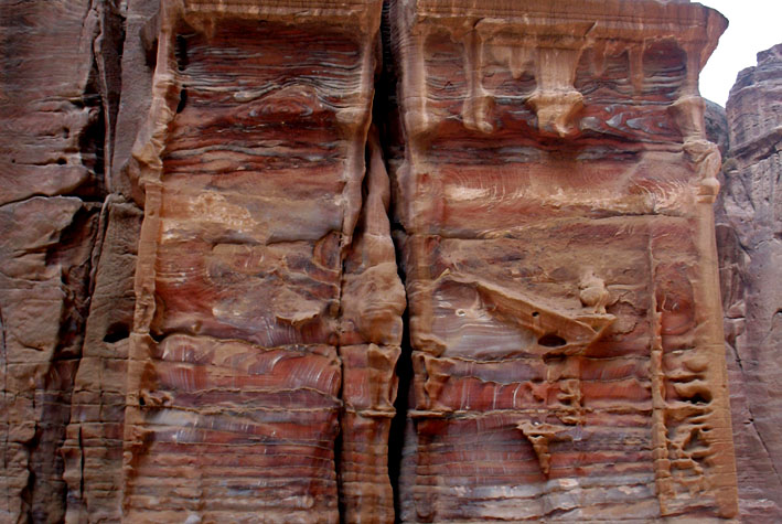 Jordan (Petra): weathering red sandstone temple facade