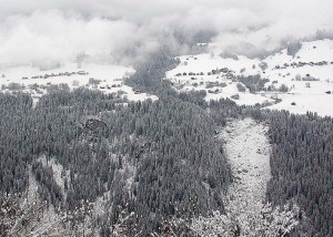 Schwarzenstein medieval castle ruin, protected at the top of the cliff at the left, with a major rock slide , which took place in June 2002, at the right. Seen from Brigels south across Vorderrheintal towards Obersaxen