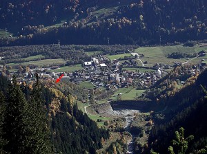 Looking down the Punteglias valley towards Trun in Vorderrheintal. Note the large basin, built to protect the village from avalanches and the like. The red arrow points towards the Cartatscha medieval castle ruin.