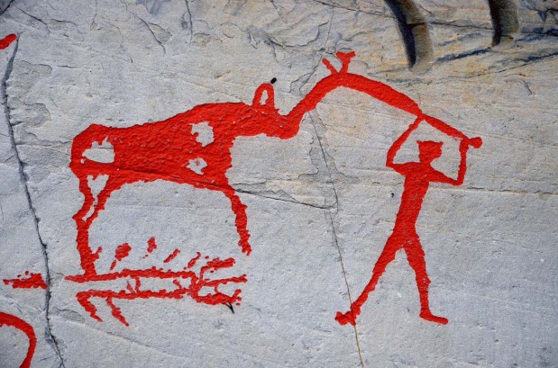 Elk and human connected with a so-called "elk-headed pole" in the Alta rock art. It is not known what the pole may represent. And what about the structure below the elk? Is it a pit so commonly used in elk hunting almost up till today? Photo: Per Storemyr