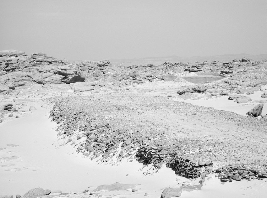 Looking east along the broad ramp leading from the extraction area (right) of the unfinished obelisk of Seti I at Gebel Gulab. Photo: Per Storemyr