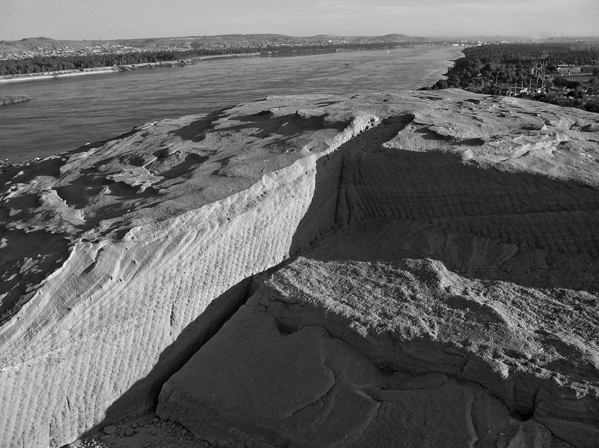 Pre-cut wedge holes along a natural fracture (at bottom center and right) and chisel tracks (on walls at left and above) in the Roman Gebel el-Qurna sandstone quarry near Aswan. Photo by PER STOREMYR.
