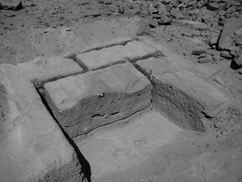 Partially extracted blocks in the Ramesside (19th-20th Dynasties) part of the Gebel el-Silsila sandstone quarry. Note the two parallel grooves at the back of the leftmost trench. Smallest scale divisions are 1 cm at center and 10 cm at right. Photo by JOHN WARD.