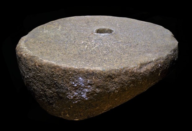Split granite boulder used as a lower stone for a rotary hand quern. Found at Obrestad, dating to the Late Roman Iron Age (300-500 AD), diameter 56.5 cm. Archaeological Museum, University of Stavanger, inventory no. S6754ø. Photo by Per Storemyr