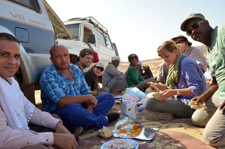 The Wadi el-Hudi team at lunch in the shade of our 4WDs. Photo by Per Storemyr