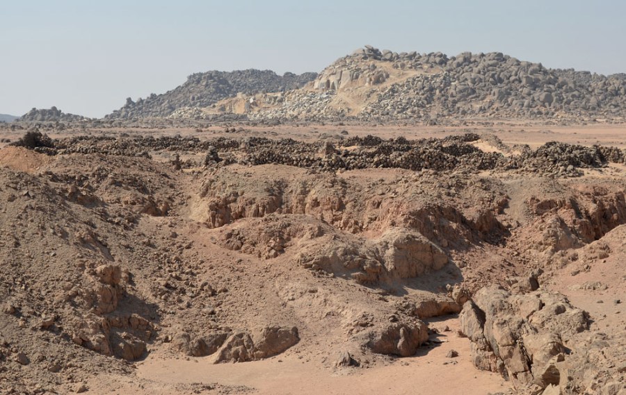 Site 9 at Wadi el-Hudi in the foreground, a modern granite quarry in the background. It may seem as if the modern quarry will soon be “eating” archaeology, but this is not the case, since the company operating the modern quarry is cooperating with the local heritage authorities and The Wadi el-Hudi Expedition. Photo by Per Storemyr