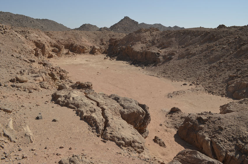 The Middle Kingdom amethyst mine at site 9 in Wadi el-Hudi. It is now filled with debris from the spoil heaps, having collected during infrequent rainstorms over 4000 years. Photo by Per Storemyr