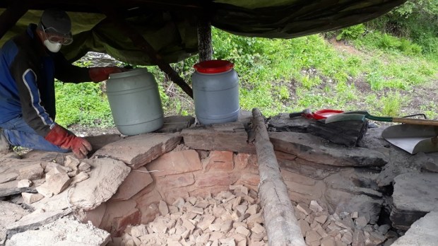 Seventh day. Eight hours in a dusty hell! Torbjørn on emptying the kiln. Manual work from above. With contstant checking of quality – done by test slaking lime in various parts of the kiln. Sorting. Well-burnt lime in one bucket, parially burnt lime in another, hardly burnt lime – thrown out of the kiln to be burnt once more later. Note security: Gloves, mask and goggles. Its a dusty, highly alkaline environment!