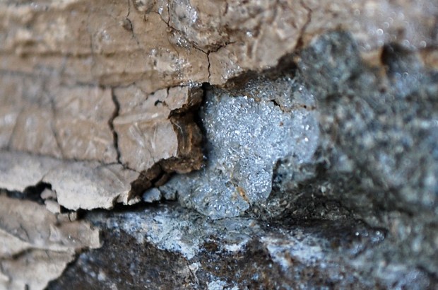 Frost heaving in masonry III: A thin lens of ice has formed below lime plaster, breaking it loose. More pieces to follow! Masonry of limekiln in Hyllestad, Western Norway. Width of image c. 5 cm. Photo by Per Storemyr