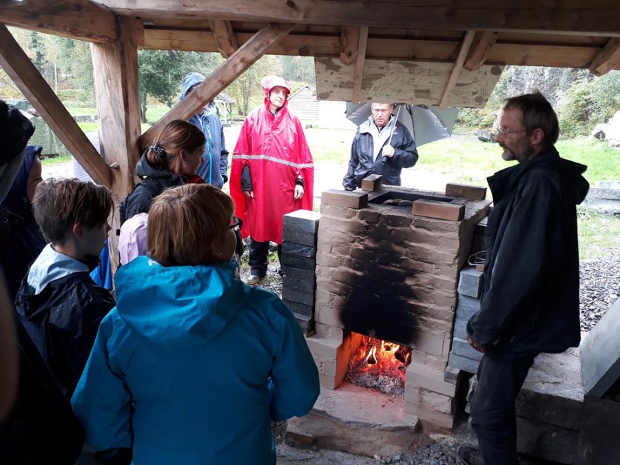 Showing visitors how a traditional lime kiln works, at Millstone Park. Photo by Per Christian Burhol.