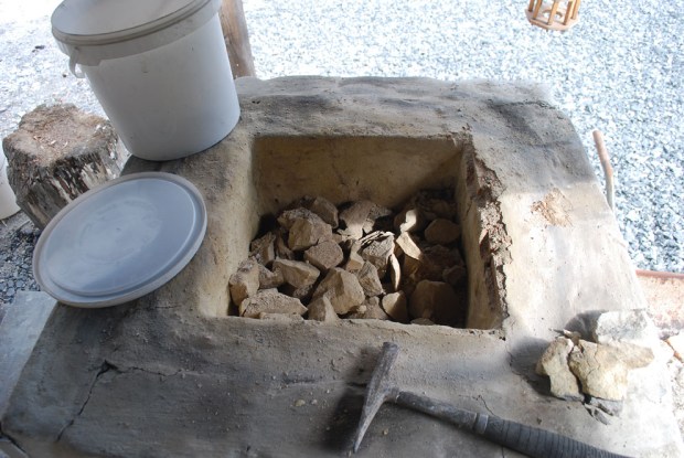 Toppen av ovnen er forsiktig fjernet og uttak av brentkalk fortsetter