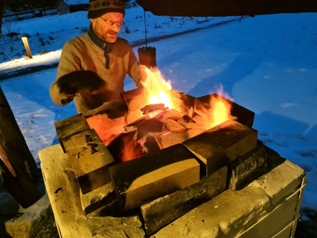 Brenningen av Kongens marmor er godt i gang. Per Storemyr ordner "topplokket" på Vesleovnen. Foto: Frøydis Arnesen