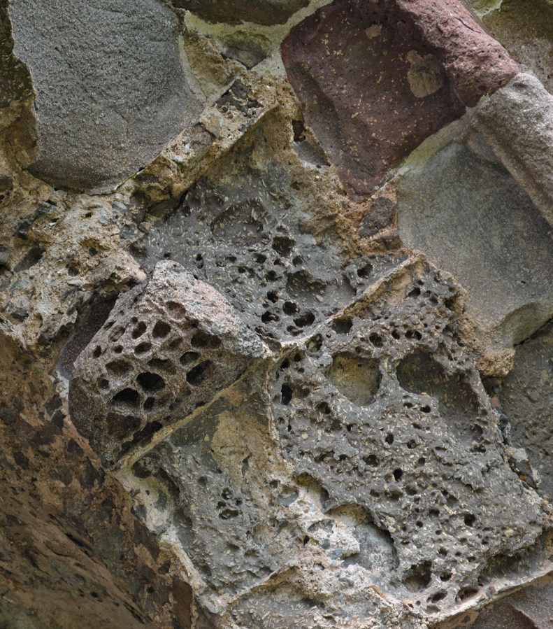 Tafoni in porous basalt used for a medieval portal at the Kirkjubøur cathedral, the Faroe Islands. Photo by Per Storemyr