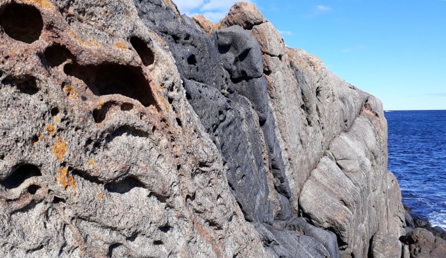 Tafoni i banded Proterozoic gneiss, Tromøy by Arendal, Norway. Photo by Per Storemyr