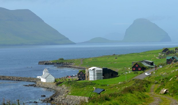 The scenic location of Kirkjubøur, with the cathedral under restoration in 2017. Photo by Per Storemyr