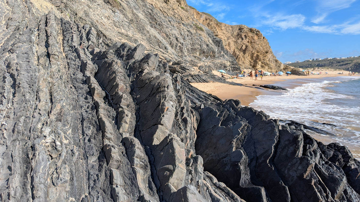 Turbidite sequences at the Amoreira beach, with the sturdier sand/siltstone sticking out and muddy layers more weathered. Photo by PS